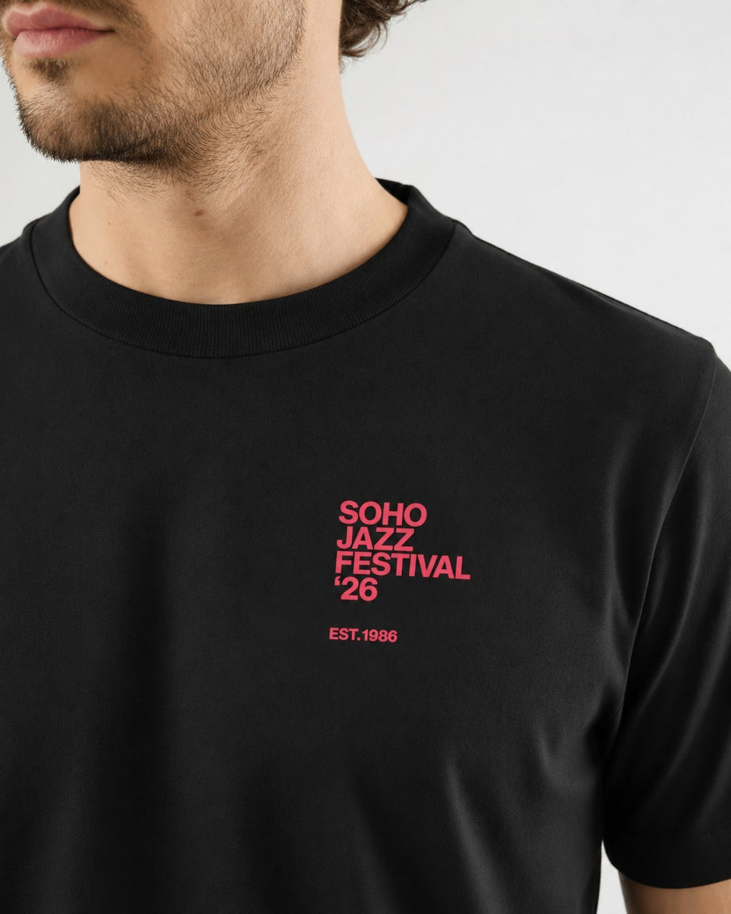 The '26 Tee in vintage black, chest print close up
