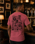 The '26 Tee in watermelon, back print of the Soho Jazz Festival sign stack, worn at a Soho bar